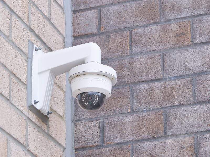 Security camera mounted on the exterior of a building photogramphed to leave ample copy space.