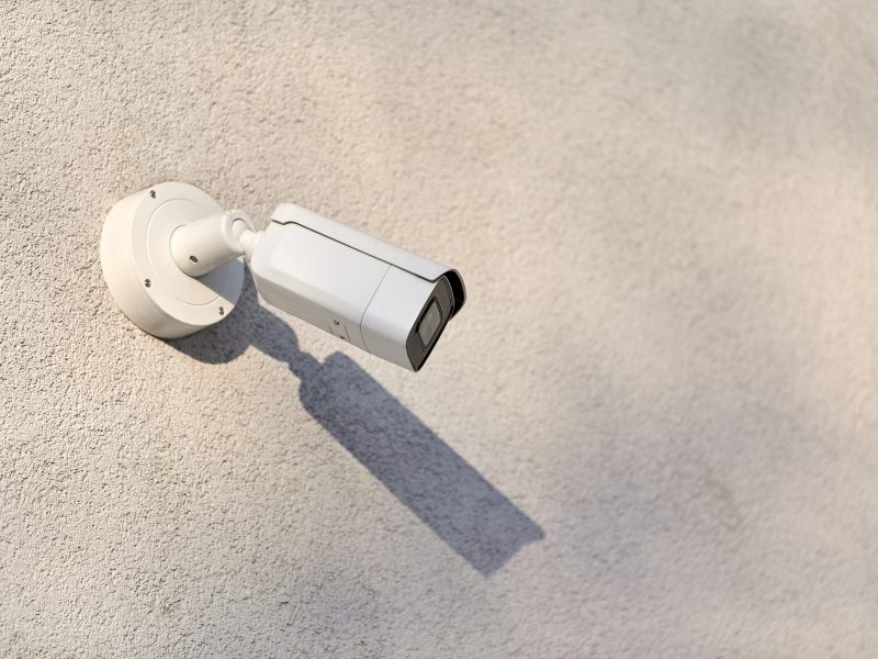 IP CCTV security camera on concrete wall background, cityscape. Protected area, industrial zone.